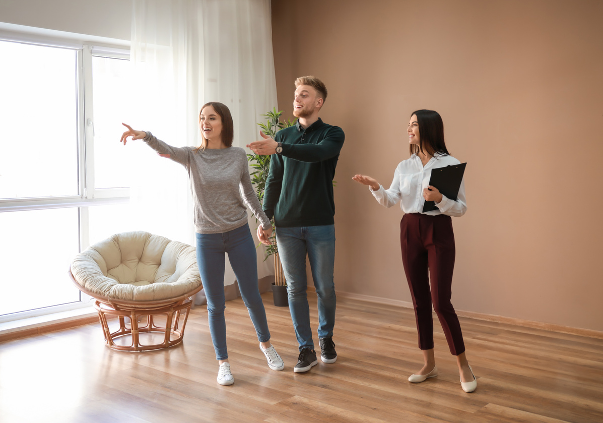 Real Estate Agent Showing Young Couple a New House